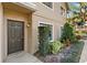 Inviting townhouse entrance with manicured landscaping around the front door at 311 Sandlewood Trl # 4, Winter Park, FL 32789