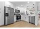 Modern kitchen featuring stainless steel appliances and bright white cabinetry at 311 Sandlewood Trl # 4, Winter Park, FL 32789