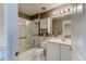 Bathroom featuring a shower-tub combination with glass doors, and a white vanity with ample storage at 3668 Peppervine Dr, Orlando, FL 32828