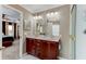 Beautiful bathroom with double sinks, wood cabinets, and natural light shining through the window at 3668 Peppervine Dr, Orlando, FL 32828