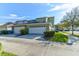 Charming townhome featuring a two-car garage, manicured lawn, and a welcoming curb appeal at 3668 Peppervine Dr, Orlando, FL 32828