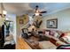 Inviting living room with hardwood floors, a ceiling fan, and a staircase to the upper level at 3668 Peppervine Dr, Orlando, FL 32828