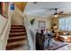 Cozy living room with a ceiling fan, stairs, and plenty of natural light shining through the window at 3668 Peppervine Dr, Orlando, FL 32828