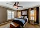 Relaxing main bedroom featuring a ceiling fan and natural light shining through the window at 3668 Peppervine Dr, Orlando, FL 32828