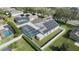 Aerial view of the home showing a backyard with a screened pool, hot tub, and solar panels on the roof at 38 Lakeview Reserve Blvd, Winter Garden, FL 34787