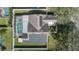 Bird's-eye view of the home showcases a backyard with a pool, spa, and expansive solar panel system at 38 Lakeview Reserve Blvd, Winter Garden, FL 34787