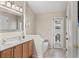 Light and airy bathroom with double sinks, a large mirror, and a sliding door to the outdoors at 38 Lakeview Reserve Blvd, Winter Garden, FL 34787