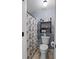 This bathroom features a shower with curtain and a wall mounted shelf for storage and decor at 38 Lakeview Reserve Blvd, Winter Garden, FL 34787