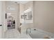 Spacious bathroom showcasing a soaking tub and double vanity sinks with neutral wall color at 38 Lakeview Reserve Blvd, Winter Garden, FL 34787