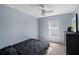 Cozy bedroom with a ceiling fan, window, and dark furniture at 38 Lakeview Reserve Blvd, Winter Garden, FL 34787