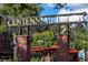 The Centennial Plaza entrance with brick columns, a decorative sign, and a glimpse of outdoor seating at 38 Lakeview Reserve Blvd, Winter Garden, FL 34787