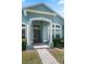 Welcoming front entry with a covered porch, elegant columns, and a view of the front yard at 38 Lakeview Reserve Blvd, Winter Garden, FL 34787