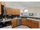 This kitchen features a stainless steel dishwasher, wood cabinets, and a long countertop space at 38 Lakeview Reserve Blvd, Winter Garden, FL 34787