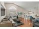 Bright living room with vaulted ceilings, wood floors, and sliding doors to the pool at 38 Lakeview Reserve Blvd, Winter Garden, FL 34787