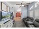 Cozy living room with plush seating, a ceiling fan, and a decorative shelving unit at 38 Lakeview Reserve Blvd, Winter Garden, FL 34787