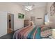 Main bedroom showcases a ceiling fan, ensuite bathroom, and a TV for relaxation at 38 Lakeview Reserve Blvd, Winter Garden, FL 34787