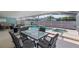 Covered pool area features a hot tub, waterfall feature, and outdoor dining set for relaxing and entertaining at 38 Lakeview Reserve Blvd, Winter Garden, FL 34787