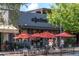 Outdoor dining with red umbrellas at a restaurant called adjectives at 38 Lakeview Reserve Blvd, Winter Garden, FL 34787