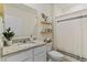 Stylish bathroom with a granite countertop, modern sink, and decorative shelving, creating a serene space at 3842 Rory Oak Circle, Apopka, FL 32703