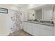 Well-lit bathroom with double sinks, granite countertops, decorative shower curtain, and tile flooring at 3842 Rory Oak Circle, Apopka, FL 32703