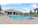 Community pool with blue lounge chairs and a covered patio at 3842 Rory Oak Circle, Apopka, FL 32703