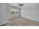 Carpeted bedroom featuring neutral walls, a ceiling fan, and window with blinds at 4004 San Gallo Dr # 107, Kissimmee, FL 34741