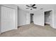 Neutral bedroom features carpet flooring, ceiling fan, and walk-in closet at 4004 San Gallo Dr # 107, Kissimmee, FL 34741