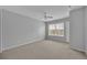 Bedroom with carpet flooring, white ceiling fan, and natural light from a window at 4012 Santa Maria Dr # 102, Kissimmee, FL 34741