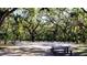 A basketball court and park featuring mature shade trees and a picnic bench under dappled sunlight at 4464 Cleary Way, Orlando, FL 32828