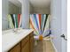 Bathroom with a colorful shower curtain and classic sink at 4464 Cleary Way, Orlando, FL 32828