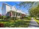 View of similar gray townhomes with well manicured lawns and landscaping on a sunny day at 4464 Cleary Way, Orlando, FL 32828