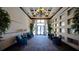 A grand lobby featuring high ceilings, decorative lighting, seating areas and lush plants at 4464 Cleary Way, Orlando, FL 32828