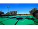 Community tennis courts with green surface and black fencing are surrounded by trees and manicured landscaping at 4464 Cleary Way, Orlando, FL 32828