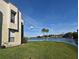 Exterior shot featuring a large body of water surrounded by well-manicured grass and two palm trees at 536 Orange Dr # 16, Altamonte Springs, FL 32701