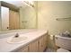 Bright bathroom featuring a sink, a mirror, and a toilet at 536 Orange Dr # 16, Altamonte Springs, FL 32701