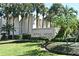 Exterior shot of the 'Royal Arms' community sign surrounded by palm trees and lush landscaping at 536 Orange Dr # 16, Altamonte Springs, FL 32701