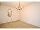 Dining room featuring carpet flooring, a chandelier, and a decorative mirror on the wall at 536 Orange Dr # 16, Altamonte Springs, FL 32701