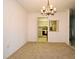 Cozy dining room featuring carpet flooring, a chandelier, and a pass-through to the kitchen at 536 Orange Dr # 16, Altamonte Springs, FL 32701