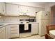 Traditional kitchen featuring cream cabinets, laminate countertops, and classic appliances at 536 Orange Dr # 16, Altamonte Springs, FL 32701