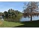 Lake view featuring lush green grass, a large tree, and the waterside at 536 Orange Dr # 16, Altamonte Springs, FL 32701