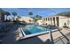 Exterior shot of a large community pool featuring lounge chairs, a fence, and palm trees at 536 Orange Dr # 16, Altamonte Springs, FL 32701