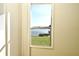 Window view of a serene lake, blue sky and green lawn area through an aluminum-framed single hung window at 536 Orange Dr # 16, Altamonte Springs, FL 32701