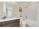 Bathroom with a large mirror, shower and tub combination, white counters and dark cabinets at 5774 Fulham Pl, Sanford, FL 32771