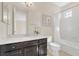 This bright bathroom features a single sink vanity with a view into the toilet and shower/tub area at 5774 Fulham Pl, Sanford, FL 32771