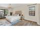 Serene main bedroom with hardwood floors, a tufted headboard, and ample natural light at 5774 Fulham Pl, Sanford, FL 32771