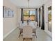 Bright dining room with modern chandelier, neutral decor, and large window offering serene backyard views at 5774 Fulham Pl, Sanford, FL 32771