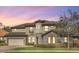 Charming two-story home featuring a tile roof, stone accents, a turret and a three-car garage at 5774 Fulham Pl, Sanford, FL 32771