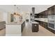 Modern kitchen featuring stainless steel appliances, granite countertops, and an expansive island at 5774 Fulham Pl, Sanford, FL 32771