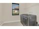 Modern laundry room with tile floor, side by side washer and dryer, and window at 5774 Fulham Pl, Sanford, FL 32771