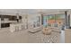 Bright open concept living room flowing into the kitchen, featuring modern furnishings and a seamless layout at 5774 Fulham Pl, Sanford, FL 32771